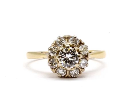 A gold diamond cluster ring,with a central brilliant cut diamond, estimated as approximately 0.50ct, claw set, to surround of