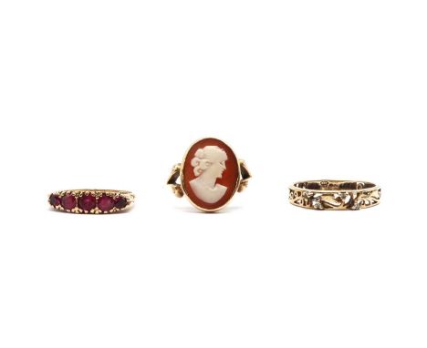 Three gold rings, comprising a gold shell cameo ring, tested as approximately 9ct gold, a 9ct gold five stone synthetic ruby 