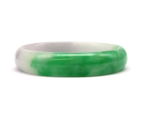 A carved jadeite jade bangle, 14mm wide, internal diameter 62mm, 53.35gCondition report: Possibly B jade.