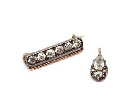 A silver and gold diamond set bar brooch,with a row of old European cut diamonds grain set to the silver bar, to gold pin and