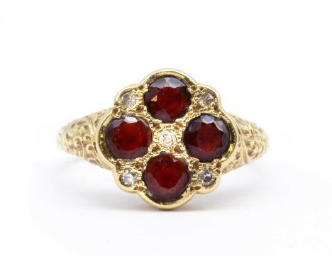 An 18ct gold garnet and diamond quatrefoil cluster ring, four round mixed cut garnets, with eight cut diamonds between, all g