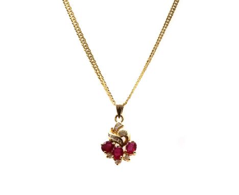 A gold ruby and cubic zirconia pendant, with three oval mixed cut rubies, possibly fracture filled, claw set, with cubic zirc