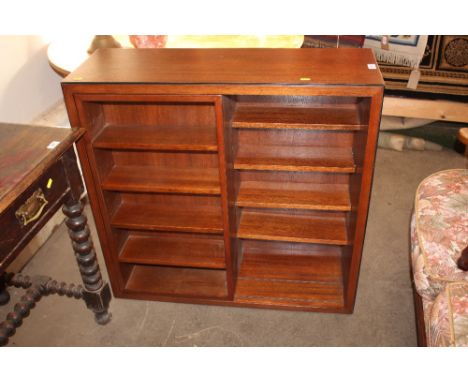 A bookcase/ CD rack with integral sliding shelf  