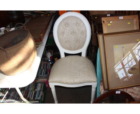 A white painted button back upholstered chair 