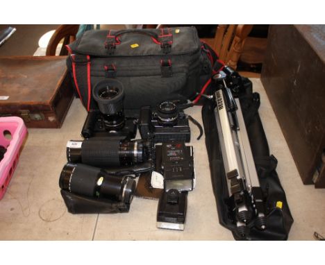 A quantity of cameras and camera lenses, tripod etc.