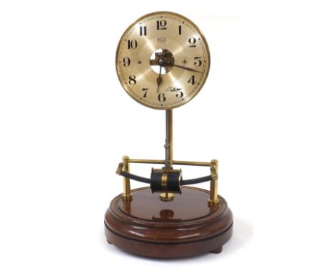 Bulle electric mantel clock, the 5.5" silvered dial with skeletonised centre, upon brass supports and a stepped turned mahoga