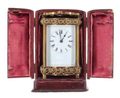 Carriage clock timepiece, within a Doucine style case with C-scroll bands, 6.5" high; also with a folding hinged Morocco leat