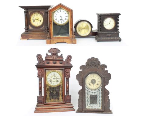 American gingerbread two train mantel clock striking on a gong, 25" high and another smaller gingerbread two train mantel clo