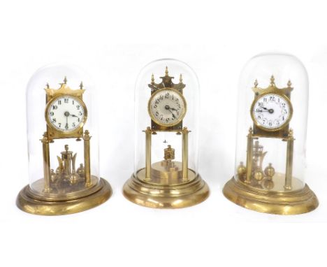 Brass torsion clock, the 2.75" silvered dial over a disc pendulum and upon a stepped circular base and under a glass dome, 11