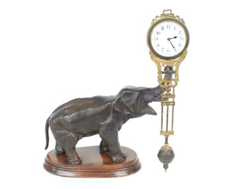 Novelty bronzed elephant mystery clock, the movement with 1.75" white dial and pendulum suspended upon the raised elephant's 