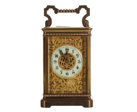 Attractive carriage clock striking on a gong, the 2" cream chapter ring enclosing a foliate filigree centre and within a gilt