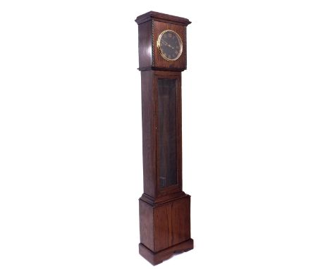 Oak electric longcase clock, the 8.5" black dial with Roman gilt enamel numerals, the case with long glazed doors and the hoo