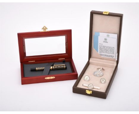 
	
		A cased Omani silver coloured dress set, stamped 925, comprising a key ring, cufflinks and tie clip; Caran d'Ache, a bla