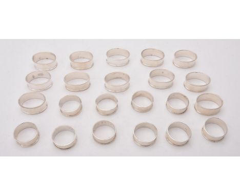 
	
		A set of ten silver circular napkin rings, maker's mark HJ, London 1999, 4cm (1 1/2in) diameter; and a set of 12 oval na