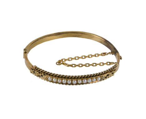 
	
		An early 20th century hinged bangle, the hinged bangle set to the front with half pearls, with ropetwist borders, stampe
