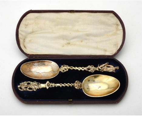 
	
		A cased pair of matched continental silver spoons, one stamped with French silverware of foreign origin mark, with figur