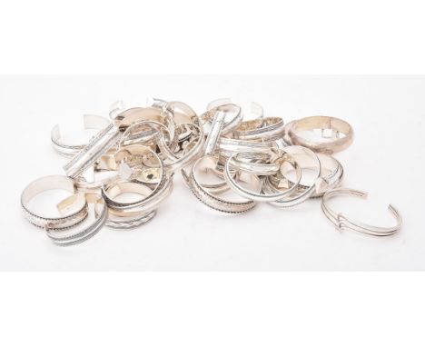 
	
		A collection of silver and silver coloured bangles, of various designs, stamped with London marks or 925, approximately 