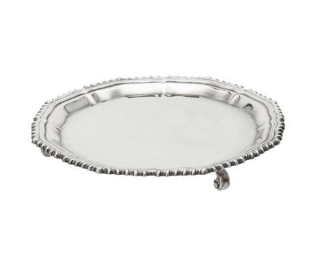 
	
		A silver shaped circular waiter by Garrard &amp; Co. Ltd., Sheffield 1985, with a gadrooned border and on three scroll f