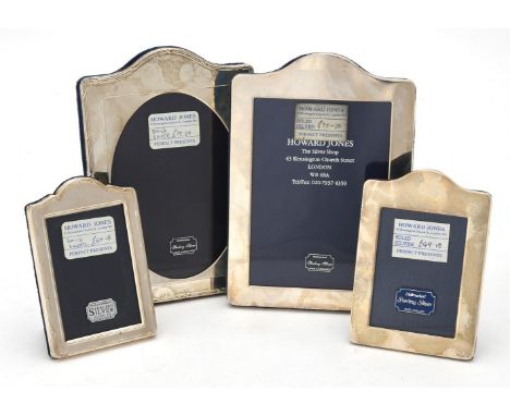 
	
		Four silver mounted shaped rectangular photo frames, various makers and dates, two with reed and stitch borders, the tal