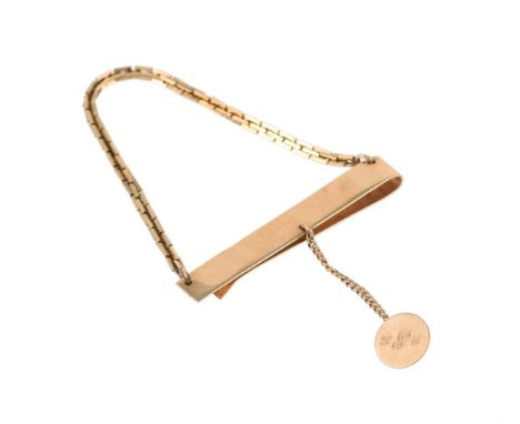 
	
		A gold coloured tie clip, the polished bar with squared belcher link chain swag, stamped 14k, with button attachment, en