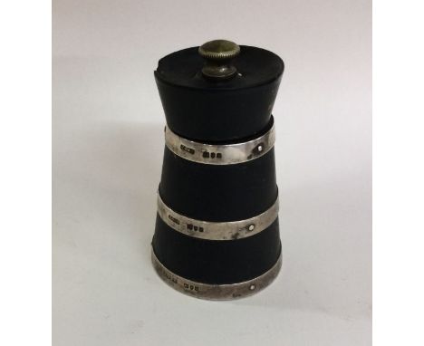 A good silver mounted and ebony pepper grinder of lighthouse form. Approx. 157 grams. Est. £30 - £50.
