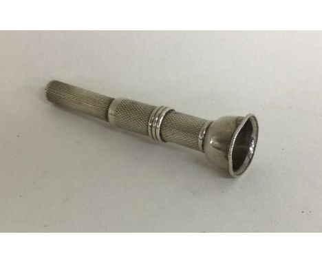 An engine turned silver cigar piercer. Birmingham. Approx. 9 grams. Est. £20 - £30.