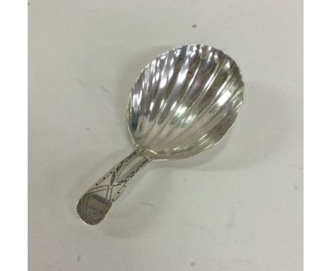A George III silver caddy spoon with bright cut decoration and fluted bowl. London. Approx. 8 grams. Est. £50 - £80.