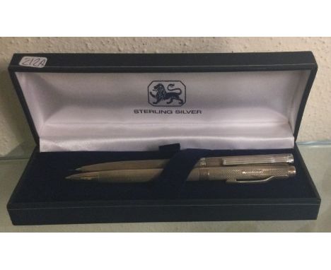 A silver engine turned pencil together with one other. Approx. 41 grams. Est. £40 - £60.