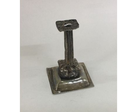 An unusual 17th Century miniature silver candlestick with fluted column. Approx. 10 grams. Est. £200 - £300.
