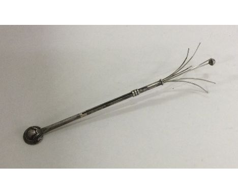 A silver swizzle stick of typical design. Approx. 5 grams. Est. £25 - £35.