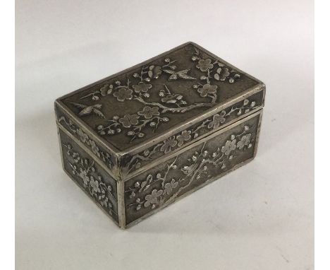 A rectangular Chinese silver hinged top box of typical form cast with birds. Approx. 139 grams. Est. £200 - £300.
