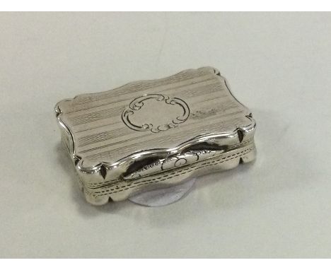 A rectangular engine turned silver vinaigrette with gilt interior. Birmingham. By DP. Approx. 14 grams. Est. £100 - £150.