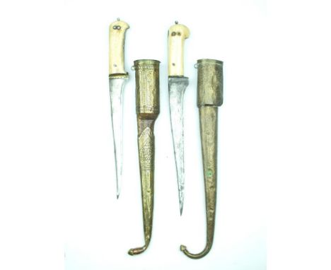 Two Indo-Persian Pesh-Kabz, the first with 26cm T-section blade, two-piece riveted bone grips, contained in its brass wrapped
