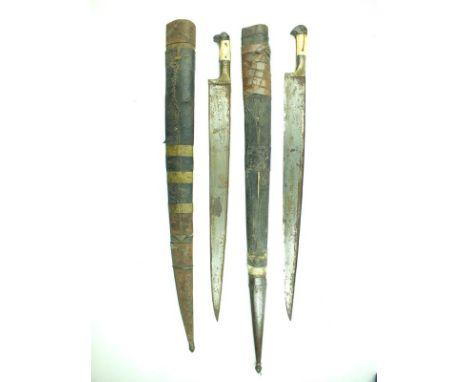 A brace of large 19th Century Khyber knives, the first with 57.5cm T-section blade, characteristic hilt with marine ivory gri