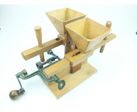 An unusual bench mounted wooden and iron shot dispenser reloading machine, the handmade box wood hoppers with sliding dispens