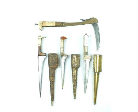 Three various Afghan Choora daggers, each with T-section blade, one with etched decoration, characteristic riveted ivory and 