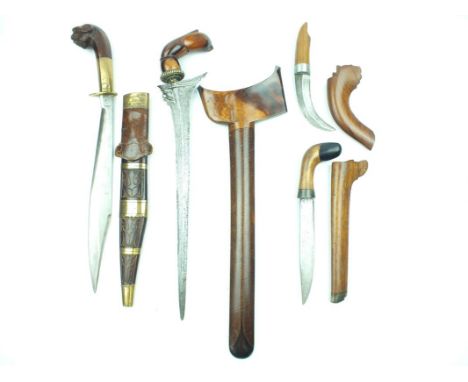 A Malayan Kris, 35.5cm watered steel blade with raised medial ridge, characteristic carved wooden hilt in the form of a styli