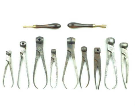 Nine various scissor bullet moulds, some marked with bore size together with two modern cleaning tools. (11)