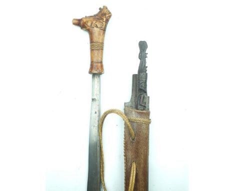 A Mandau, 62.5cm heavy blade inset with brass dot decoration along the back edge, the latter also chiselled towards the tip, 