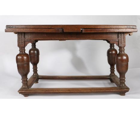 A mid-17th century oak draw-leaf table, Flemish, circa 1650Having a fully cleated triple-boarded top, above a draw-leaf to ea