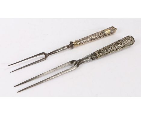 Two German two tined forks. circa 1700, the first with foliate and mask cast handle above a vacant cartouche, 21.5cm long, th