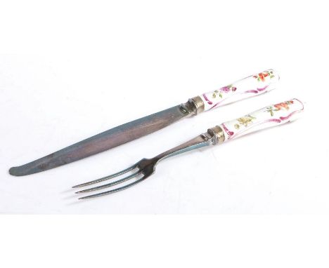 Meissen porcelain handled knife and fork, circa 1740, the handles with puce scroll and polychrome foliate decoration, with st
