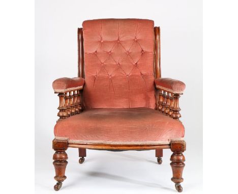 Victorian mahogany armchair, the button upholstered back flanked by serpentine uprights, the upholstered arms raised on turne