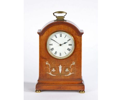 Edwardian inlaid mahogany mantle clock, with an arched pediment with a brass carrying handle above a circular white dial with