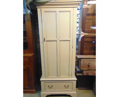 A contemporary single wardrobe with factory painted finish in off white with quarter panelled door over a single frieze drawe