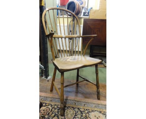 A Georgian Windsor comb back elbow chair with elm seat, beech and ashwood sticks, raised on turned supports