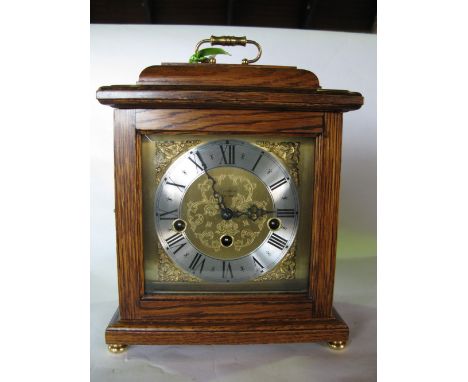 An oak cased Woodford three train musical shelf/bracket clock, fitted with a 5.5inch brass dial, the clock 27 inches high