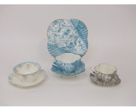 A collection of Wileman-Foley china tea wares comprising a turquoise printed trio of fluted form, a grey printed cup and sauc