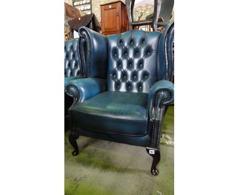 A pair of chesterfield style button and wing back lounge chairs in blue with studded decoration with cabriole front feet (2)
