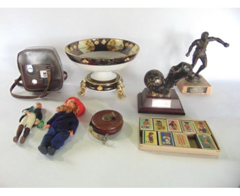 A mixed lot to include noritake pedestal comport, various footballing trophies, tape measures, dolls, etc